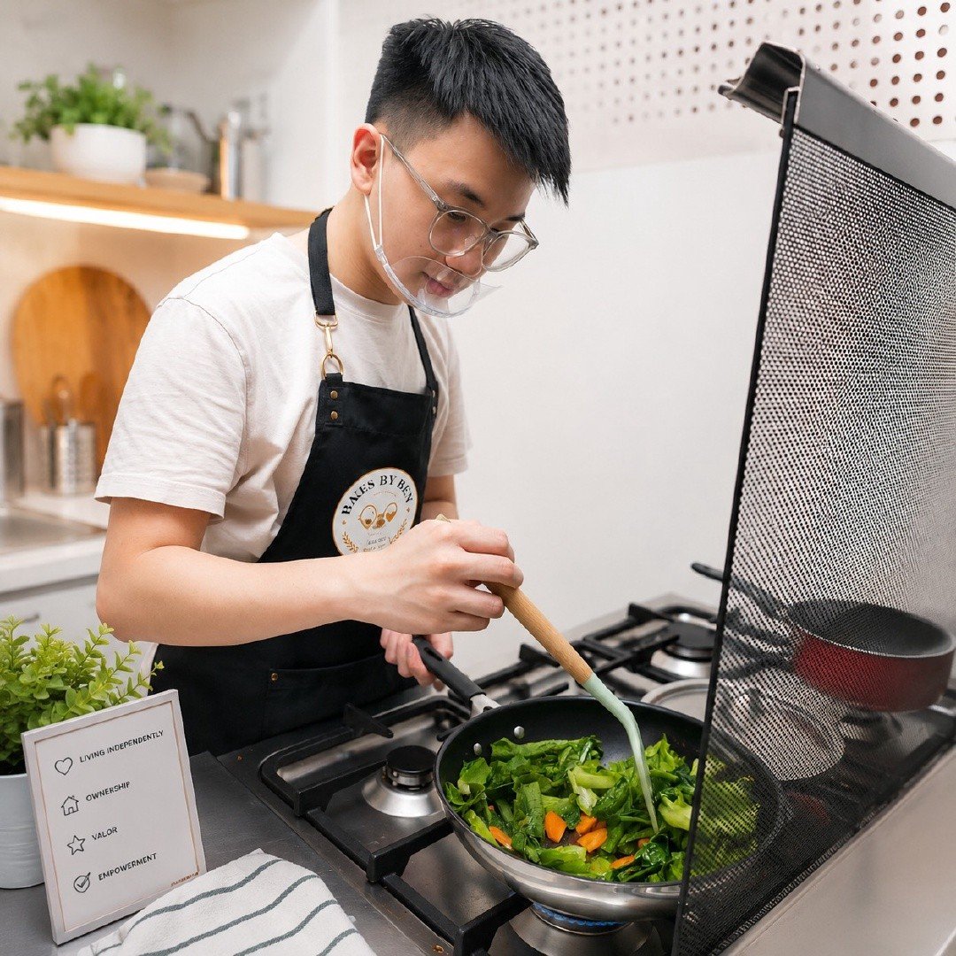 Ben wearing safety glasses, stir-frying vegetables at the stove with a splatter guard